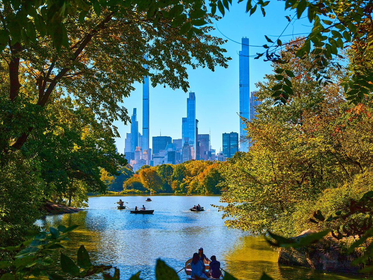 Rowboats on Central Park lake with Manhattan skyline in background