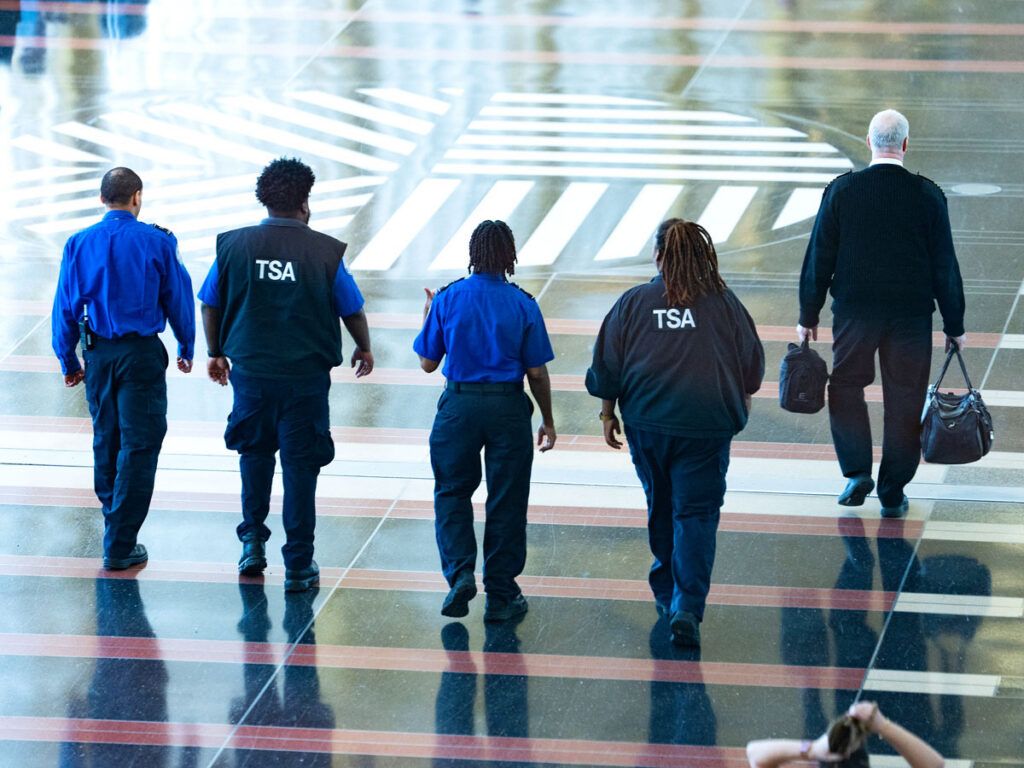 TSA officers walking through terminal