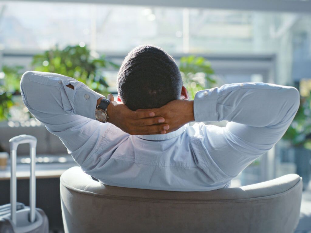 Traveler relaxing in chair in airport lounge