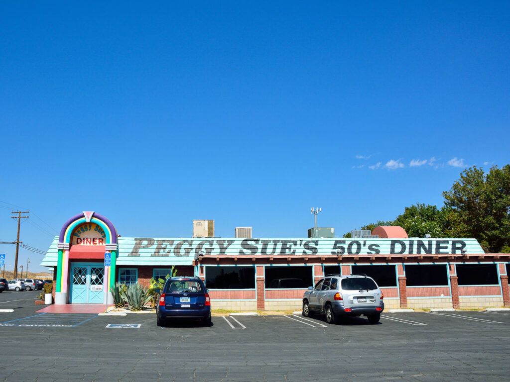 Cars parked outside of Peggy Sue's 50's Diner in Yermo, California 