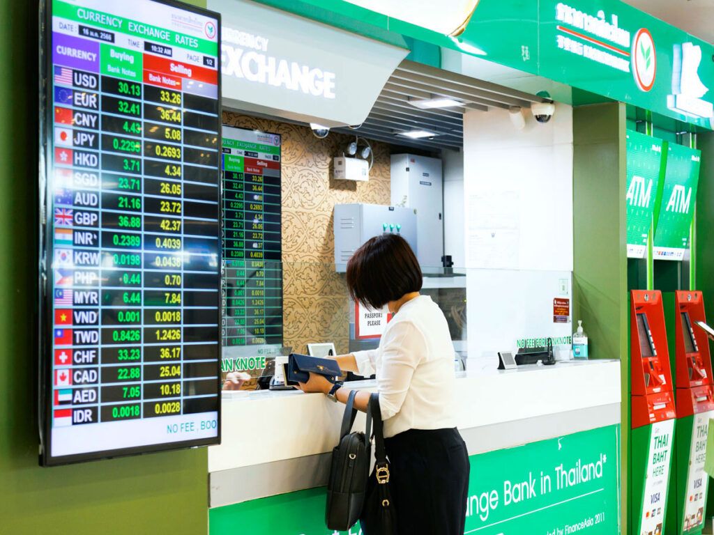Traveler at airport currency exchange kiosk