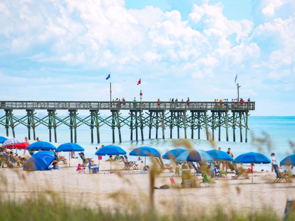Beach goers and pier in Myrtle Beach, South Carolina
