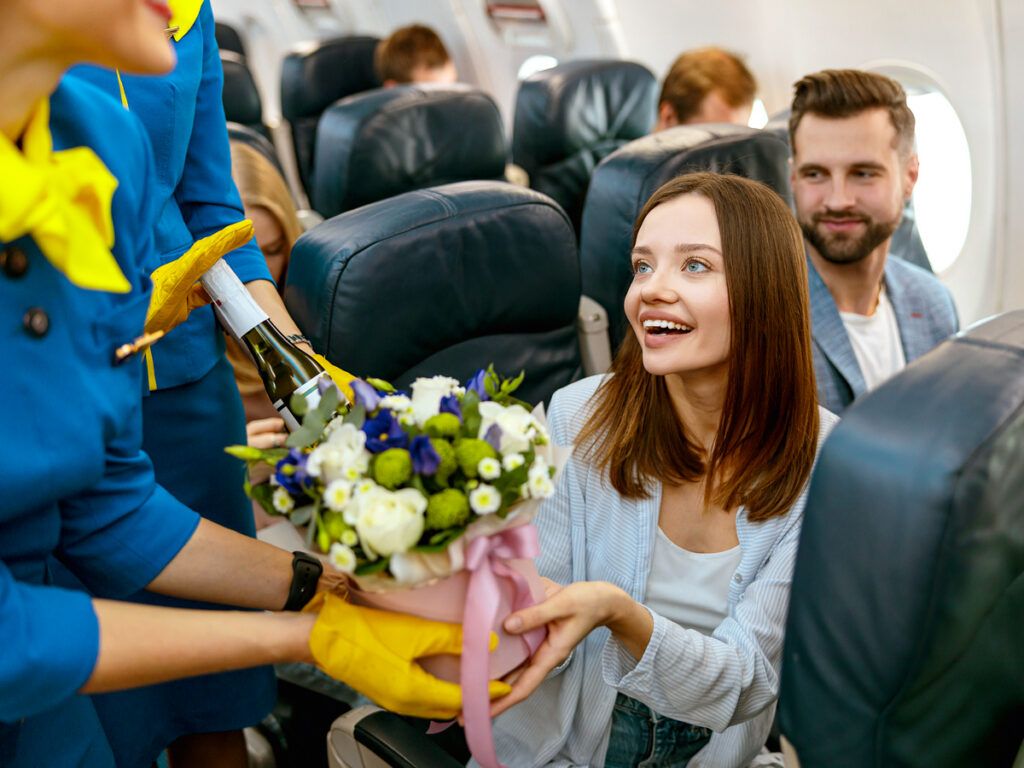 Airline passenger receiving bouquet of flowers
