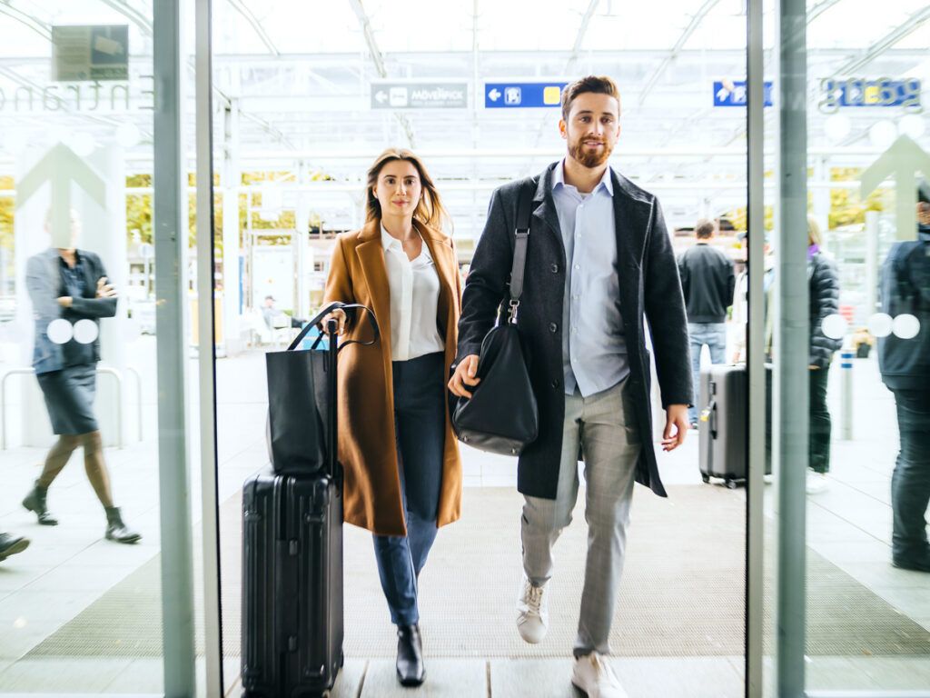 Two travelers walking into airport